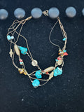 M.C’s multi-strand bohemian cord necklace with turquoise stones, earthy beads, and antique metal accents.