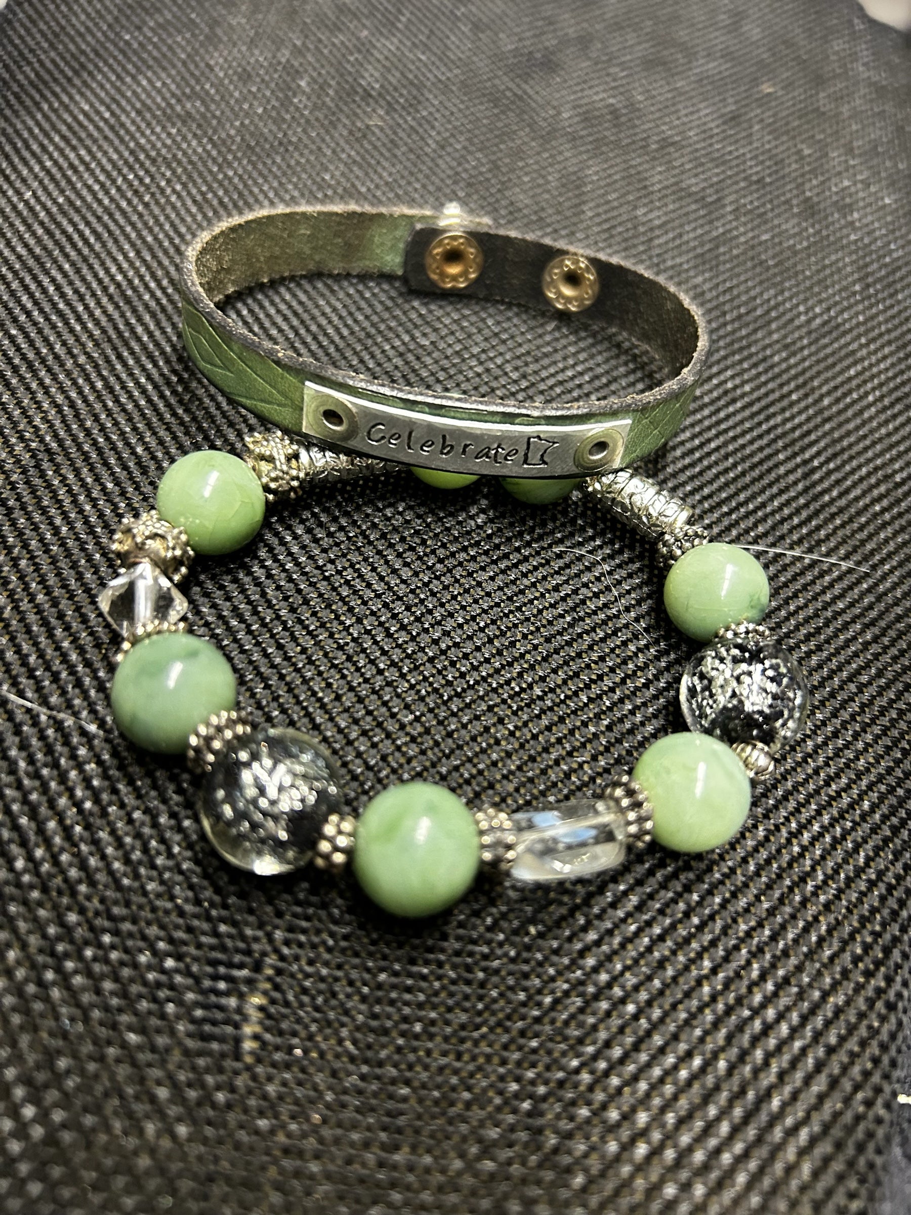 M.C’s two-piece bracelet set featuring a sage green leather cuff with Celebrate plate and mint stone beaded bracelet.